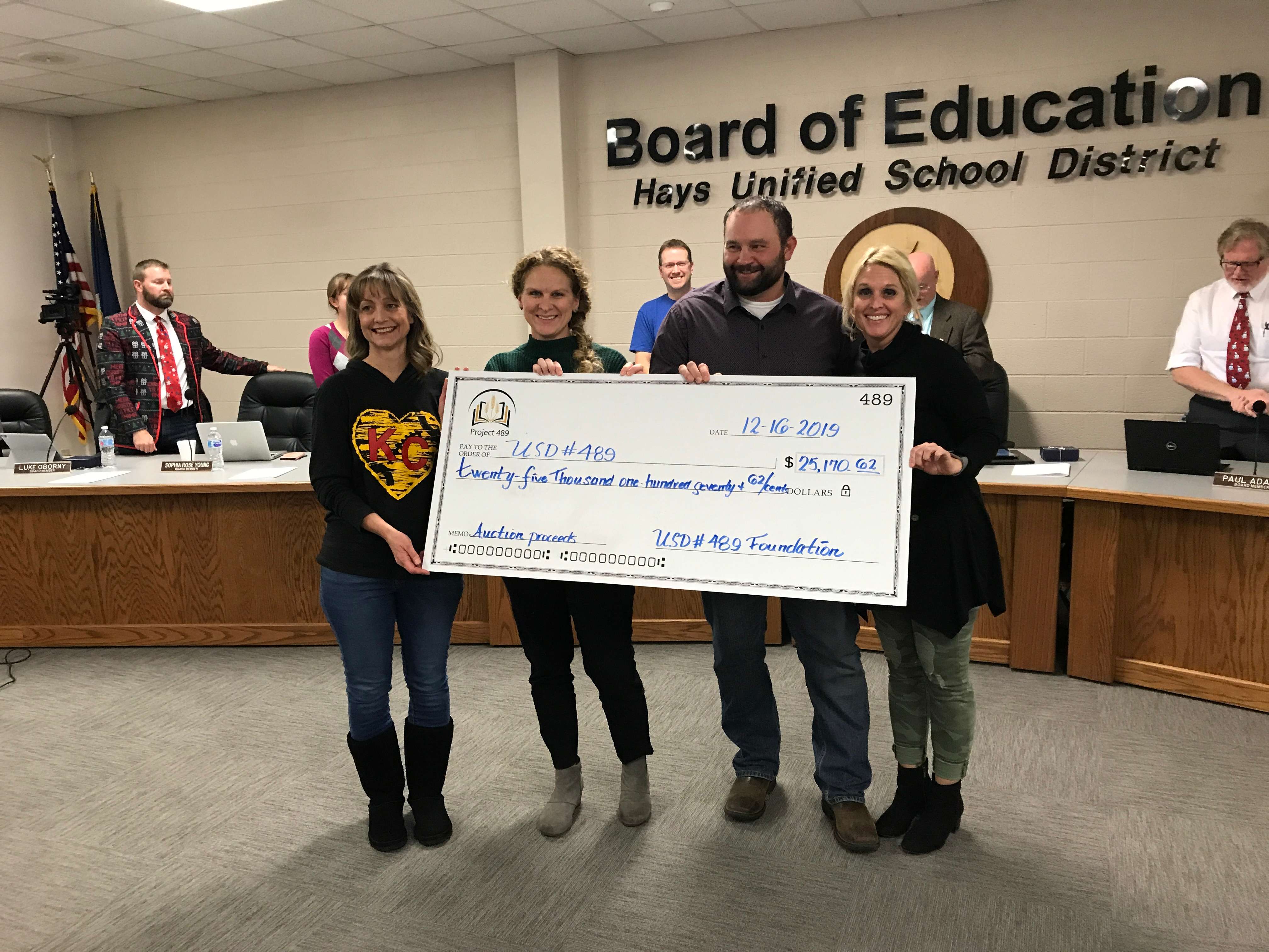 Members of the&nbsp;USD 490 Endowment for Education Excellence present a check to the school board Monday night for proceeds of the foundation auction and dinner in October.