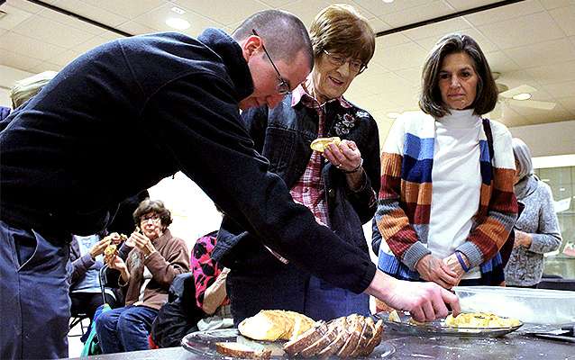 Guests of the Hays Public Library sample Cathy's Breads after a baking demonstration Thursday night.