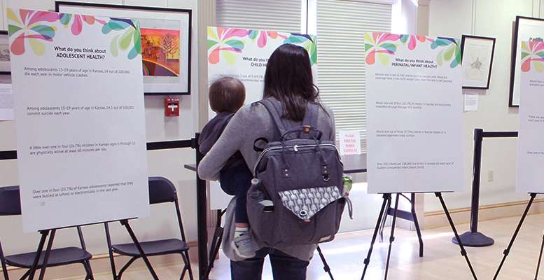 A mother and her child attend a maternal and child health open house Wednesday at the Hays Public Library.
