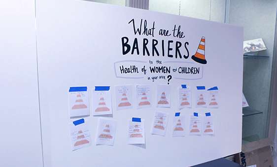 Families offer ideas of barriers to health for women and children at a KDHE open house Wednesday at the Hays Public Library.