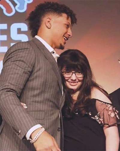 Sophia Linenberger receives a hug from Patrick Mahomes during a charity gala in November. Linenberger was on hand to receive a $15,000 check from Mahomes' foundation on behalf of Children's Mercy Hospital. Courtesy photo