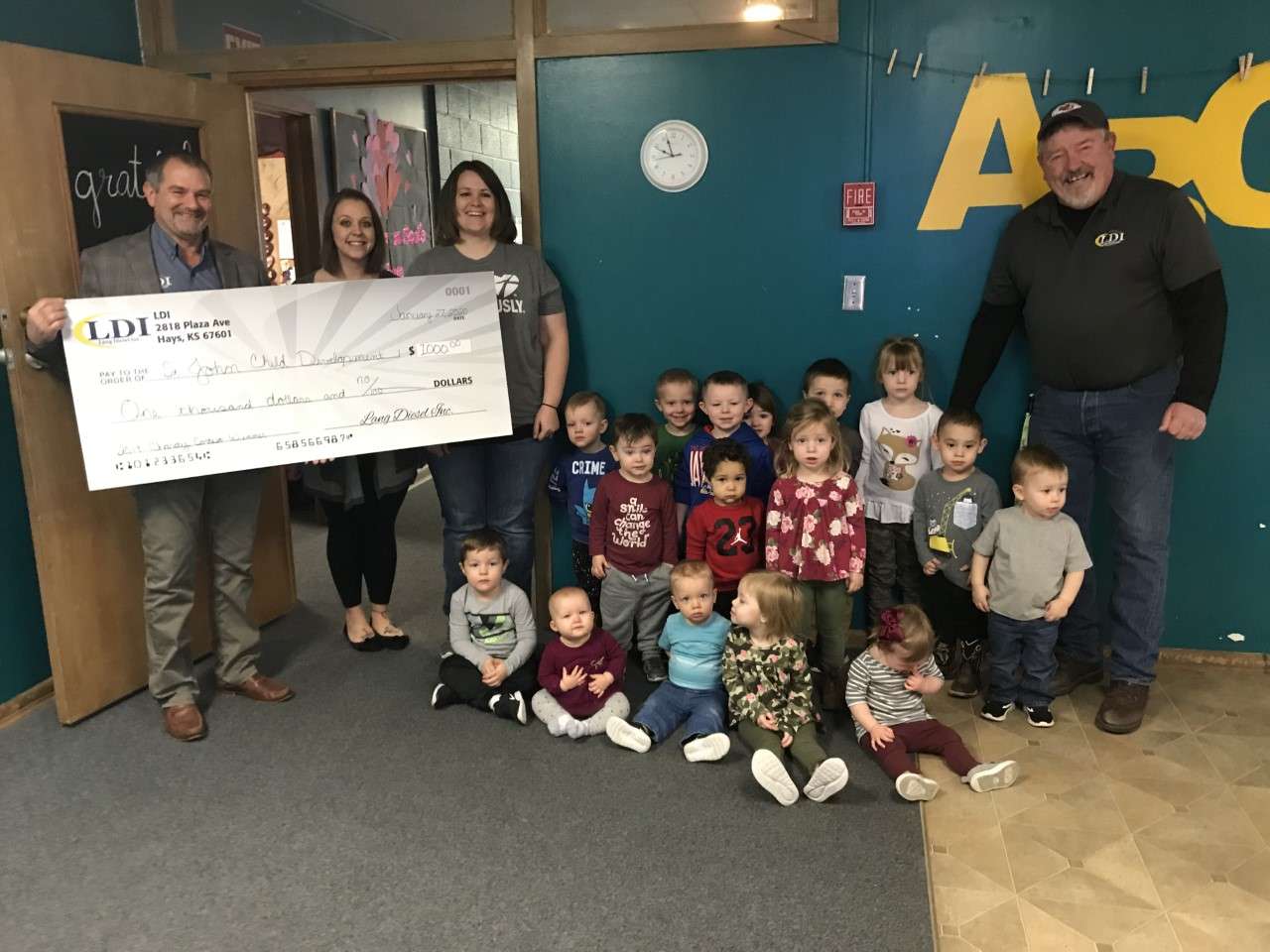 LDI $1,000 Charity Donation Winners: St. John's Child Development Center. Pictured are Brian Lang, Jodi Fullbright, Megan Clemons, Doug Barrett, and kids from the Child Development Center.