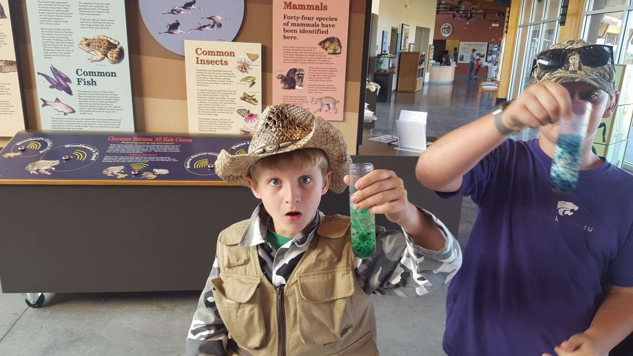 A participant from a past KWEC Drop-In STEM activity marvels at the wonders of science.