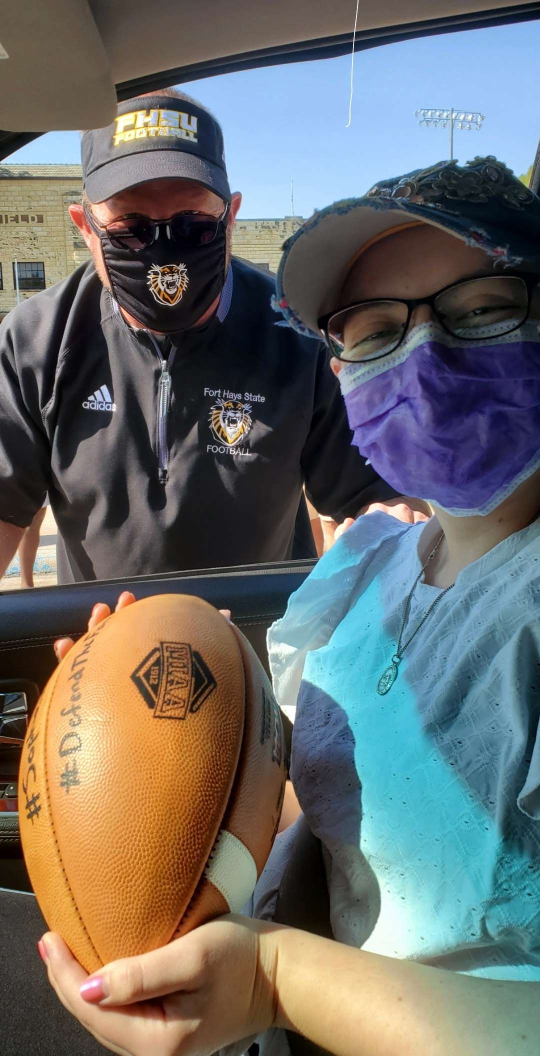 Sophia Linenberger is presented a football by the FHSU football team before she heads to treatment at Children's Mercy Hospital in Kansas City, Mo. Submitted photos