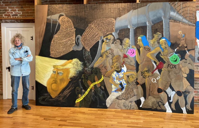 <b>Mike Hartung with his 2020 painting “Golden Turd.” </b>Photo by Marsha Howe, courtesy Kansas Reflector