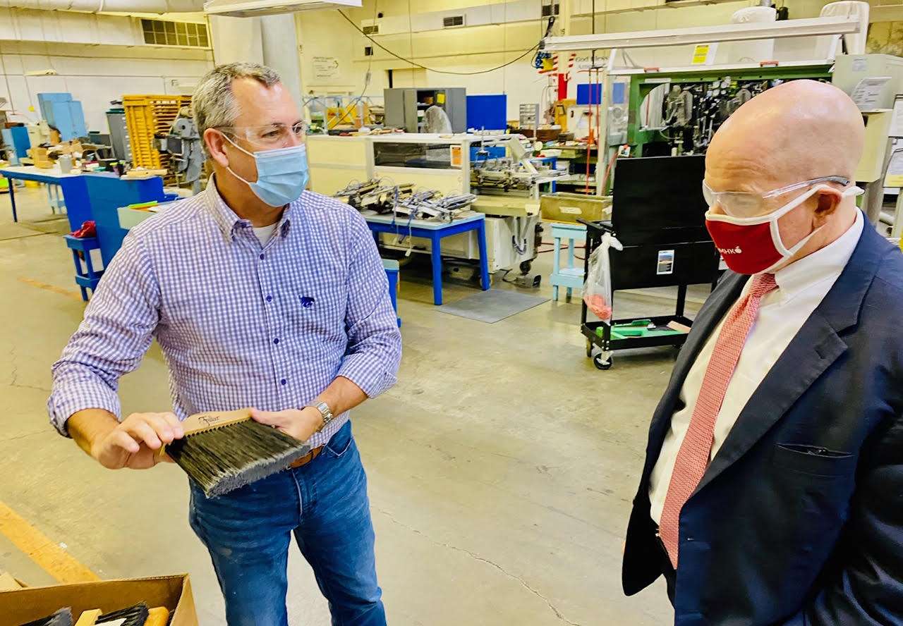 Mark Chalfant, chief executive officer of Fuller Industries LLC, and Bill Murphy of the Kansas Department of Commerce, discuss one of Fuller’s many products