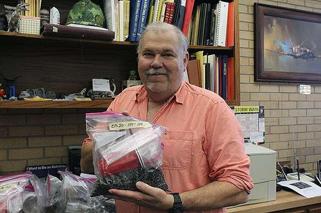 Steve Arthur, Ellis Public Library director, holds up a kit that will be used to grow&nbsp;New Mexican chimayo chili peppers. Citizen scientists across the nation are trying to develop the best method for growing the peppers. The methods that produce the peppers with the best taste and heat will be replicated on an upcoming mission to the International Space Station.