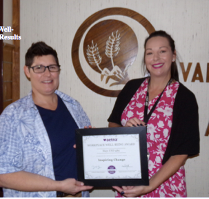 USD 489 HR coordinator Faith Lochmann, left, receives the&nbsp;Bronze Inspiring Change Aetna Well-Being Award for the efforts of the district's Wellness Committee&nbsp;during the last year.
