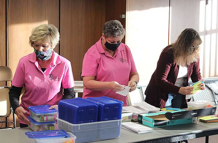 From left Nancy Jeter, Wonder Women League co-chairwoman, and members Mary Karst and Terri Braun pack self-soothing boxes for children Tuesday at the Hadley Center.