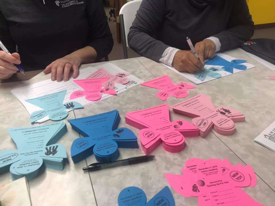 Volunteers fill out angels for the Teaming up for Tots Angel Tree program last Christmas. Courtesy photos