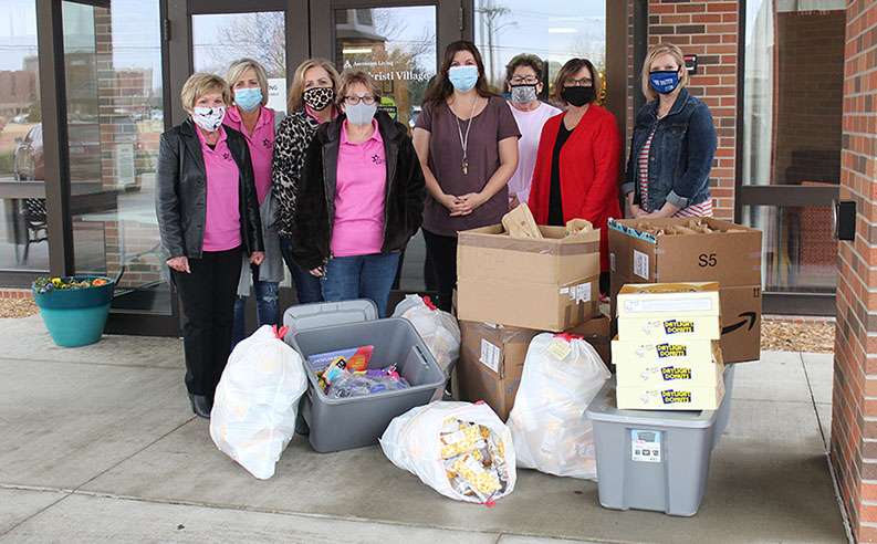 Members of the Wonder Women League Elder Care Committee donate gift bags for elders, as well as popcorn and donuts for the care staff to the Ascension Living Via <wbr style="font-size: 18px; font-style: normal;">Christi Village on Monday. Pictured center is Jamie Gray, the center's director of activities.