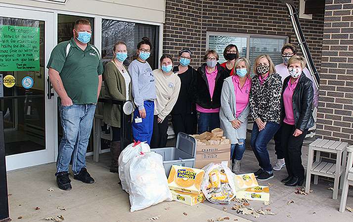 Members of the Wonder Women League Elder Care Committee present gifts for the resident and staff of the Good Samaritan Society on Monday. Also pictured are staff members (not in order) Delayne, Lindsey, Tiffany, Jackie and Dannie.
