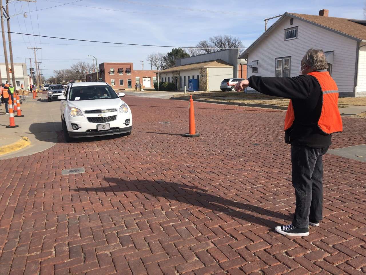 Dennis Lasich directs traffic to turn in the drive-through lane to Gella's.