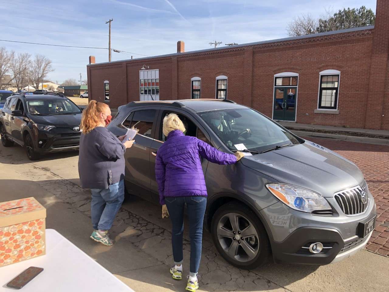 Laura Allen and Linda Stahlman man the registration table. Cards with the number of meals ordered were placed on vehicle windshields. 