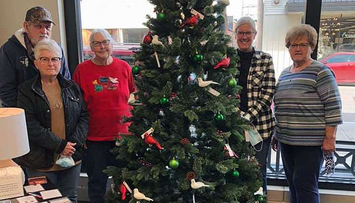 Members of the Center for Life Experience grief support groups stand next to a memory tree at Jackie Creamer's Dance Studio, 1004 Main St., Hays.