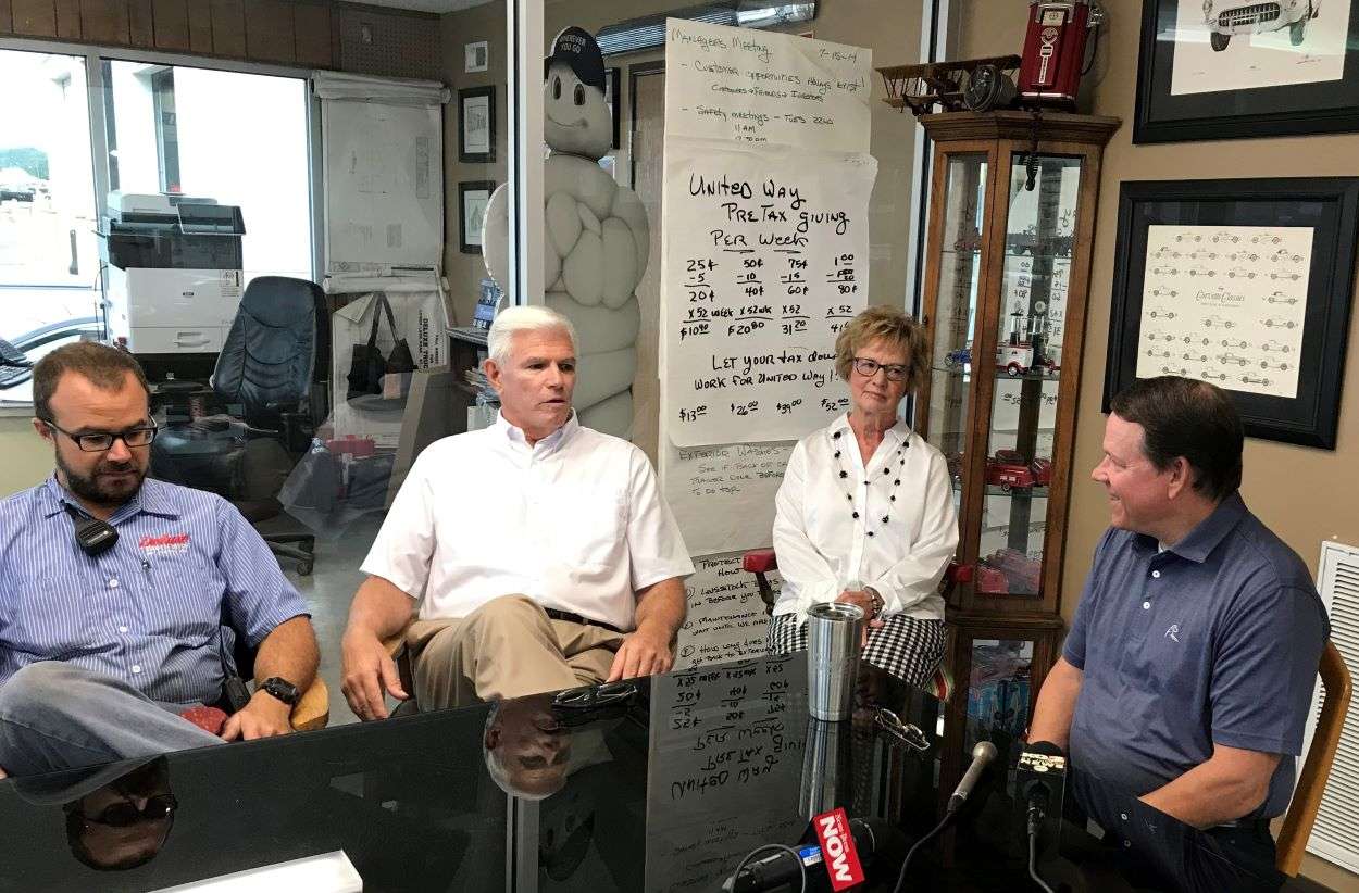 Bob Wollenman (middle left) speaks with Congressman Sam Graves during a visit Graves made to Deluxe Truck Stop