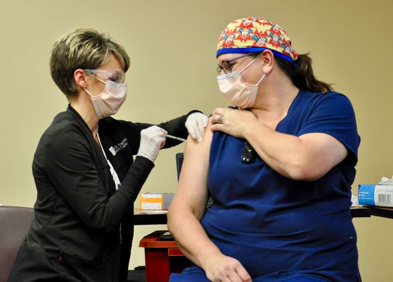 <b>Bethanie McDowell, Infection Prevention Director at Salina Regional Health Center, administered the first COVID-19 vaccine to ICU nurse Kelly Winslow. </b>Photo courtesy SRHC