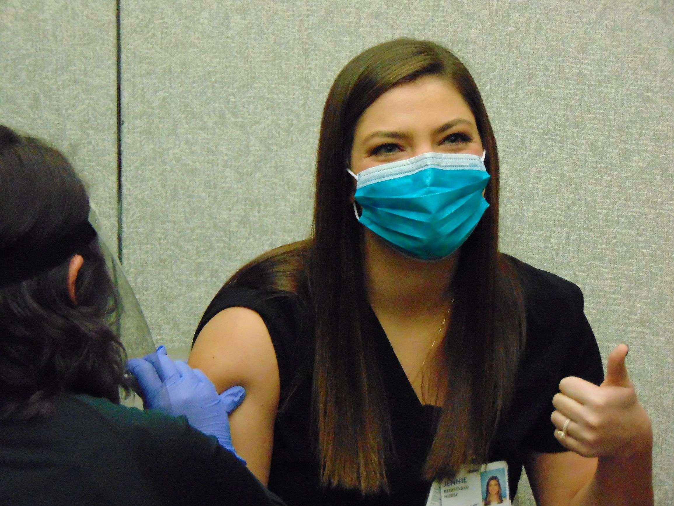Jennie Smith, an ER and ICU nurse at Mosaic, poses as she receives her COVID vaccine Tuesday./Photo by Tommy Rezac