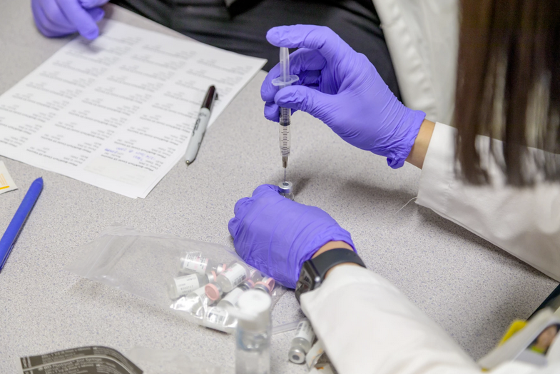 A worker at Truman Medical Center in Kansas City prepares doses of Pfizer-BioNTech's vaccine against the virus that causes COVID-19 -Photo courtesy Truman Medical Center