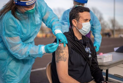 Josh Gering, Paramedic and Assistant Director of Riley County Emergency Medical Services was the first to receive the vaccine Tuesday afternoon-photo RCHD