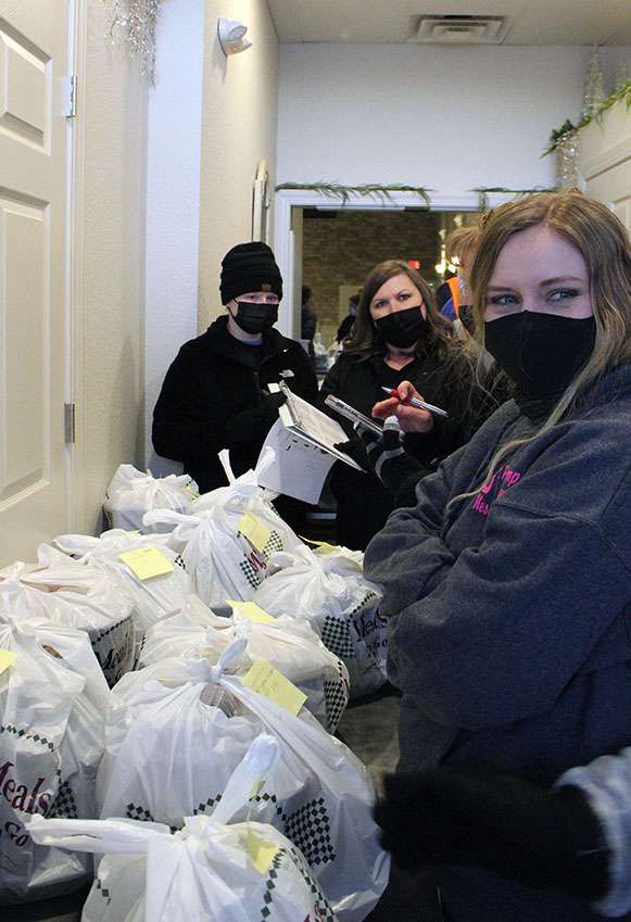 Volunteers sort Christmas dinner Wednesday at Thirsty's.