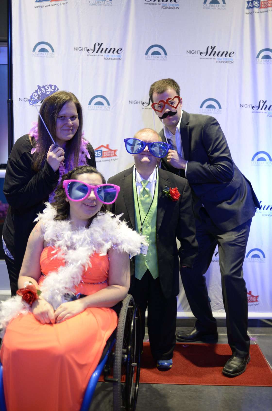 Night to Shine guests pose at a photo booth during last year's event.