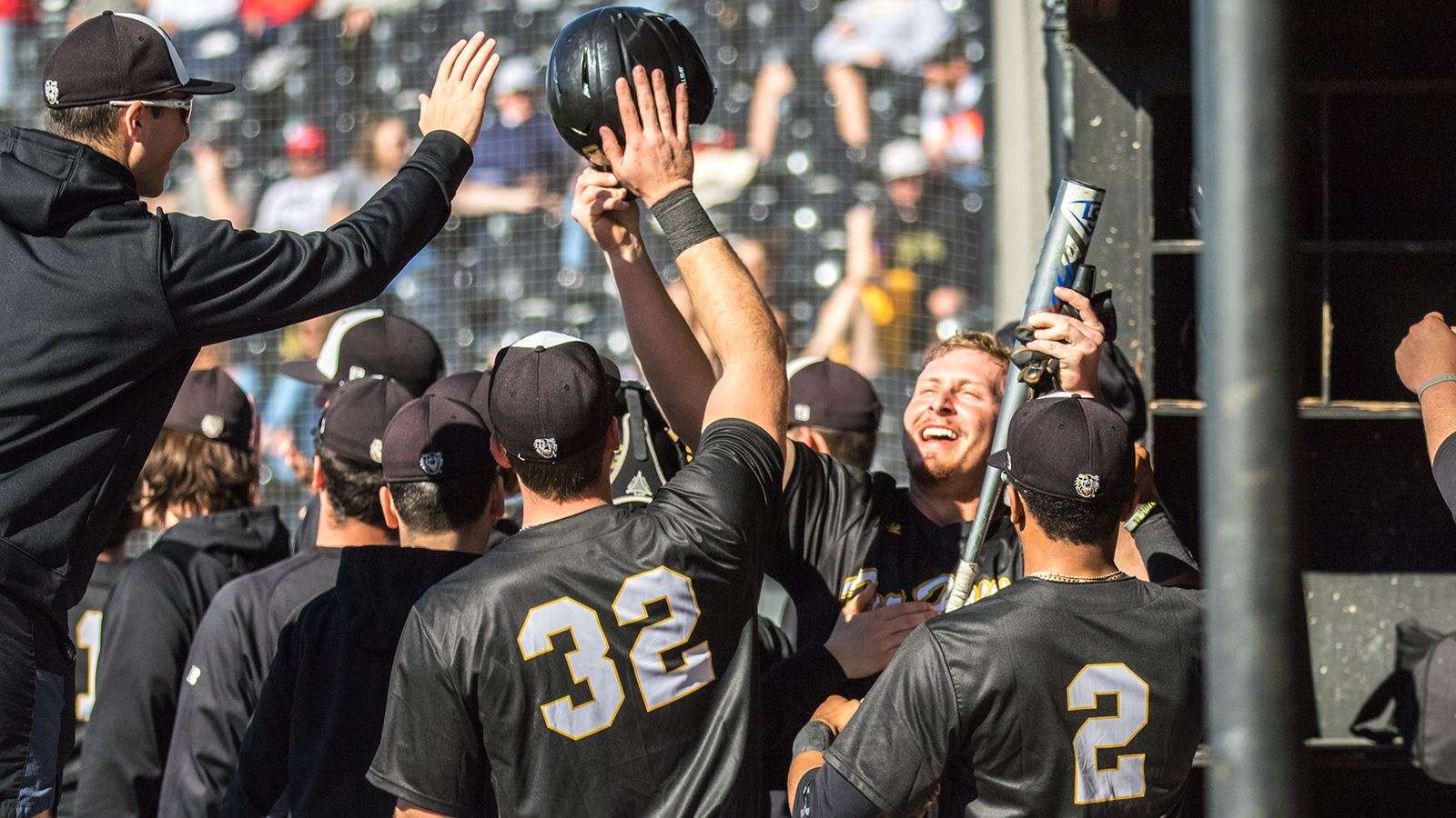 Members of the FHSU baseball team celebrate in the dugout during a game this season. (Allie Schweizer photo)