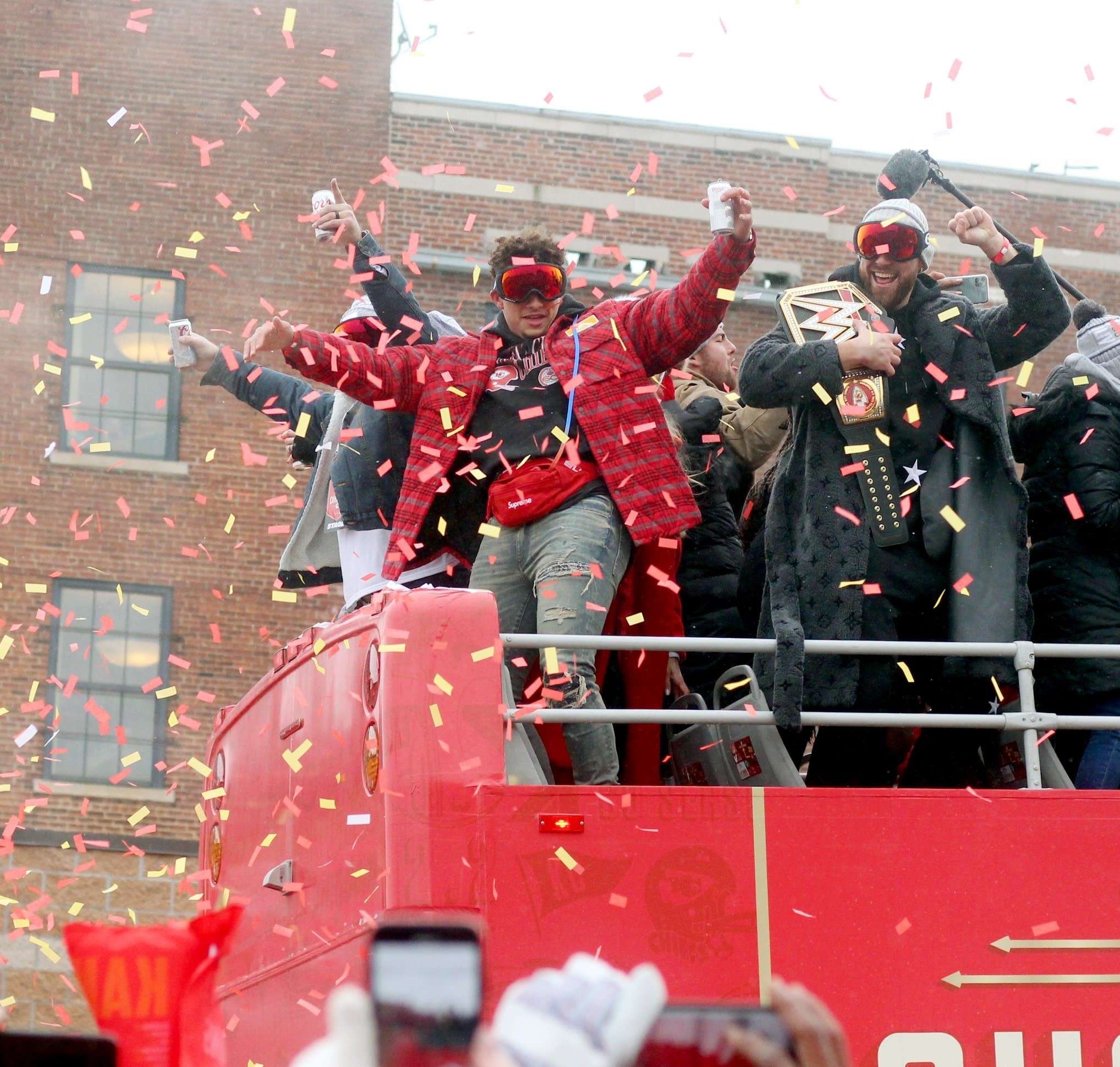 Chiefs Quarterback Patrick Mahomes (left) and Tight End Travis Kelce celebrate with the crowd during the Super Bowl parade.