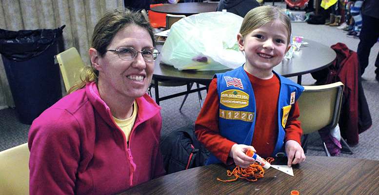 Jessa Fuertges, 5, Daisy Girl Scout, with the help of her mother Kerri, makes a fox face craft at the Girl Scout Cookie Kickoff Sunday at First United Methodist Church in Hays. Girl Scout cookie sales start on Thursday, Feb. 13.