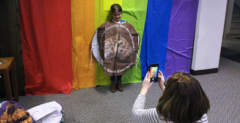 A Girl Scout dressed in a cookie costume has her picture taken at the cookie kickoff on Sunday in Hays. S'mores are one of the cookie flavors for sale this year.