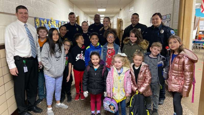 <b>Officer Jacob Hansel of the Salina Police Department, left at back, is part of the 262nd basic training class that donated to help students pay for lunches. Hansel and some of his classmates can be seen here with students from Morgan Elementary School in Hutchinson. </b>Photo courtesy KLETC