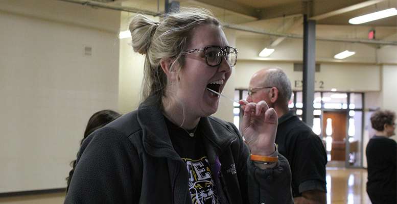 Brynn Niblock, FHSU junior in pre-med from Hoxie, swabs her cheek as part of the sign up for the Be the Match bone marrow registry Feb. 6 at Gross Memorial Coliseum.