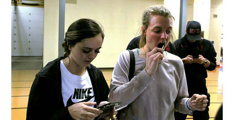 Kaci Finch, FHSU junior in sport and exercise therapy, and Hailey Dart, freshman in early childhood education, both of Garden City, sign up for the bone marrow registry Feb. 6 during a Tiger home basketball game.