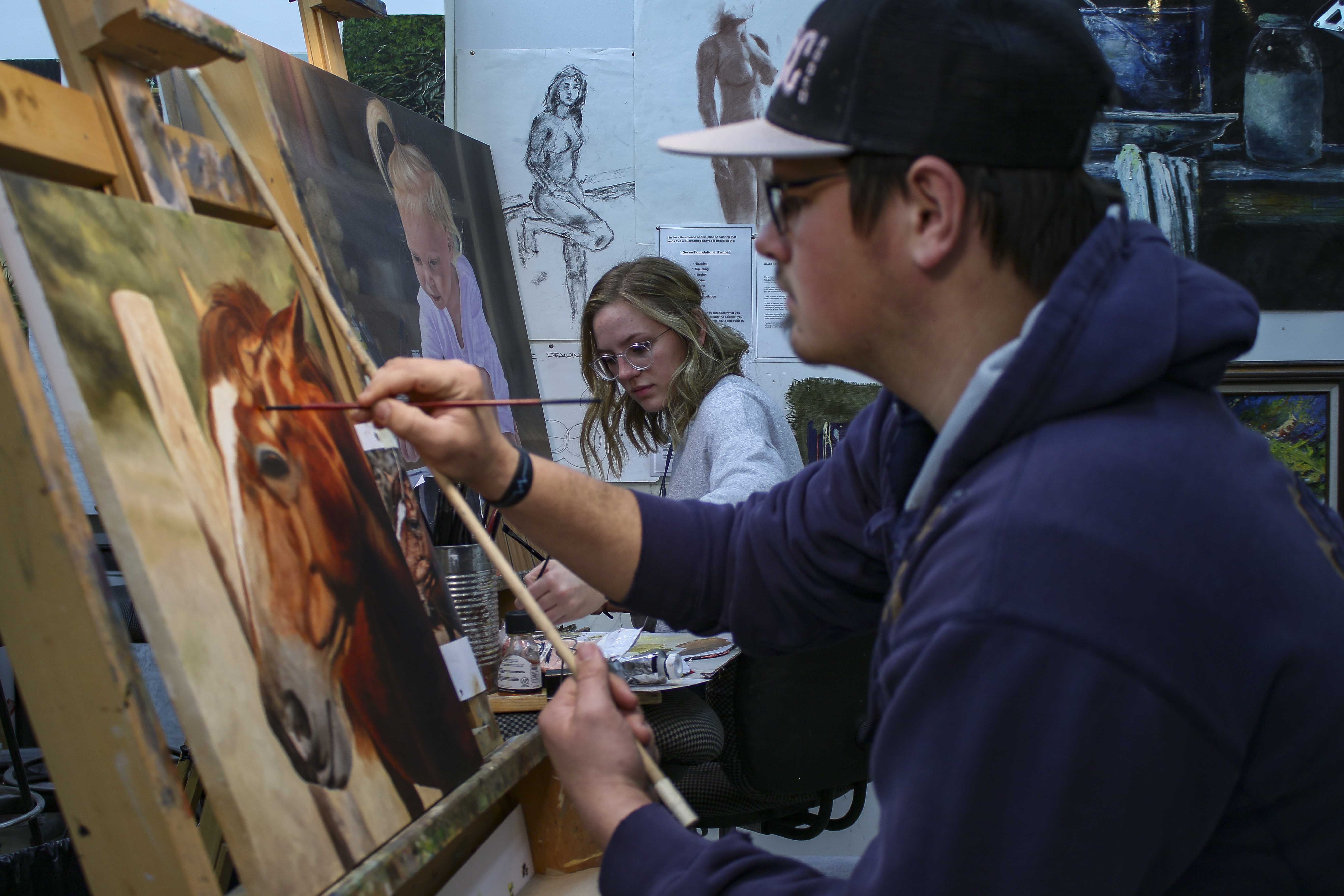 <i>McCook Community College Associate of Fine Arts students work on their capstone projects ahead of a series of showings in March. Pictured left to right are: Hana Brock and Marshall Still.</i>