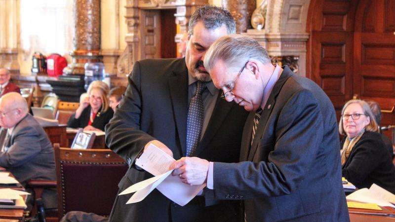 Sens. Richard Hilderbrand (left) and Mike Thompson (right) speak during a floor debate during the last week of February. Stephen Koranda / Kansas News Service