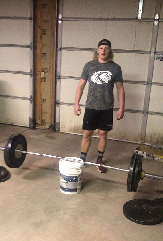 Chadron State senior Cole Thurness works out in Thurness' father's garage in Gillette, WY Monday night.