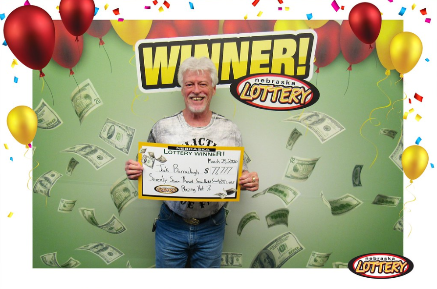 Jack Barraclough posing with his check from the Nebraska Lottery