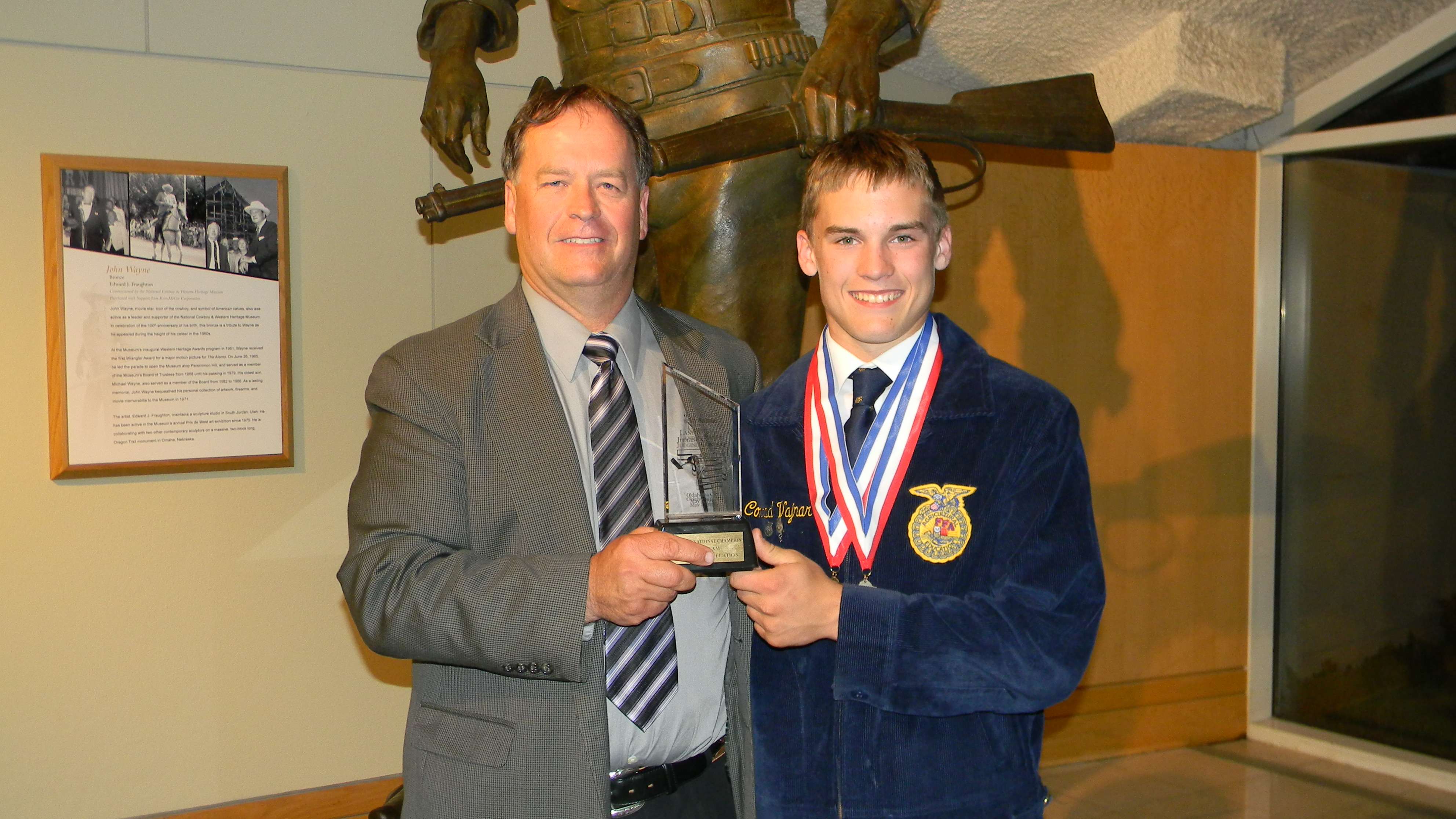 HHS ag teacher Curt Vajnar with his oldest son, Conrad, who had just won seventh in the 2016 national FFA competition.