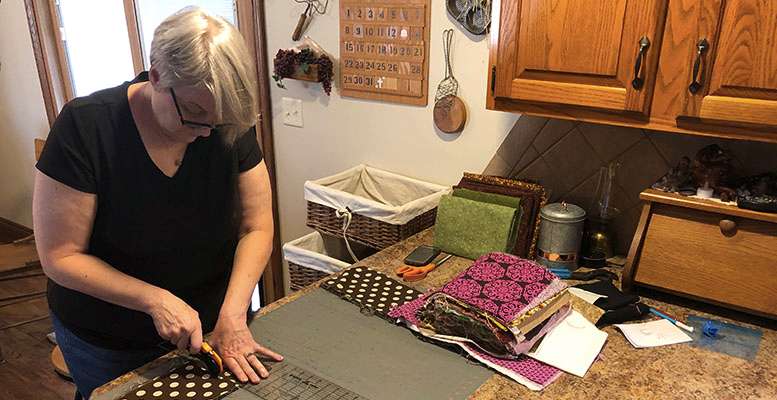 Rhonda Meyerhoff, Wonder Women League co-chair, cutting fabric for protective masks for HaysMed. Courtesy photo