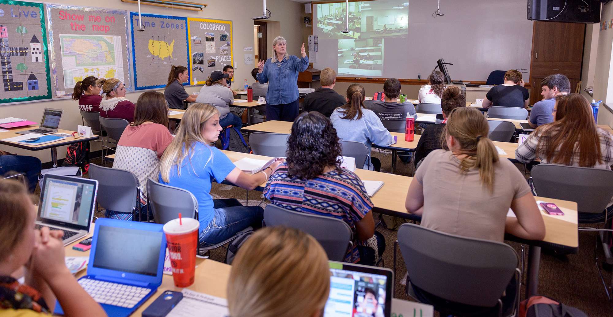 Dr. Karen Enos, professor of education, works with students on a project during a Teaching Elementary/Middle School Social Studies class. (Photo by Daniel Binkard/Chadron State College)