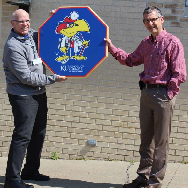<b>MHS CEO Harold Courtois, left, presents Dr. Doug Sheern with a retirement gift in front of MHS colleagues and staff outside Memorial Hospital. </b>Photos courtesy MHS
