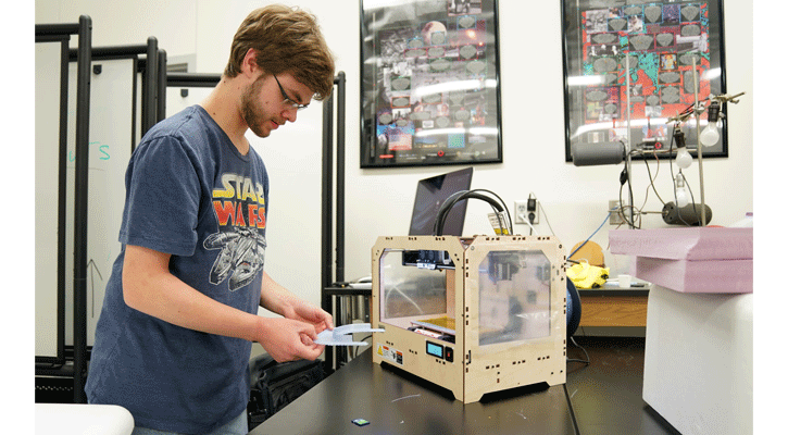 <i>North Platte Community College student Packer Daily works on a face shield for Great Plains Health. Daily is creating the shields using a MakerBot 3-D printer in NPCC’s engineering department.</i>