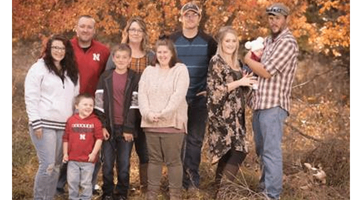 Cynthia Huhman, of Merna, stands with her family who inspired her to earn two associate degrees through MPCC at age 52. Pictured left to right are: Huhman’s daughter-in-law JaLisa, son Ryan, grandson Ryker, son Timmy, Huhman, daughter Bethany, son Reece, daughter Brittany, granddaughter Delilah and Brittany’s fiancé Jesse Toof. (Photo courtesy of Hillary Williams Photography)
