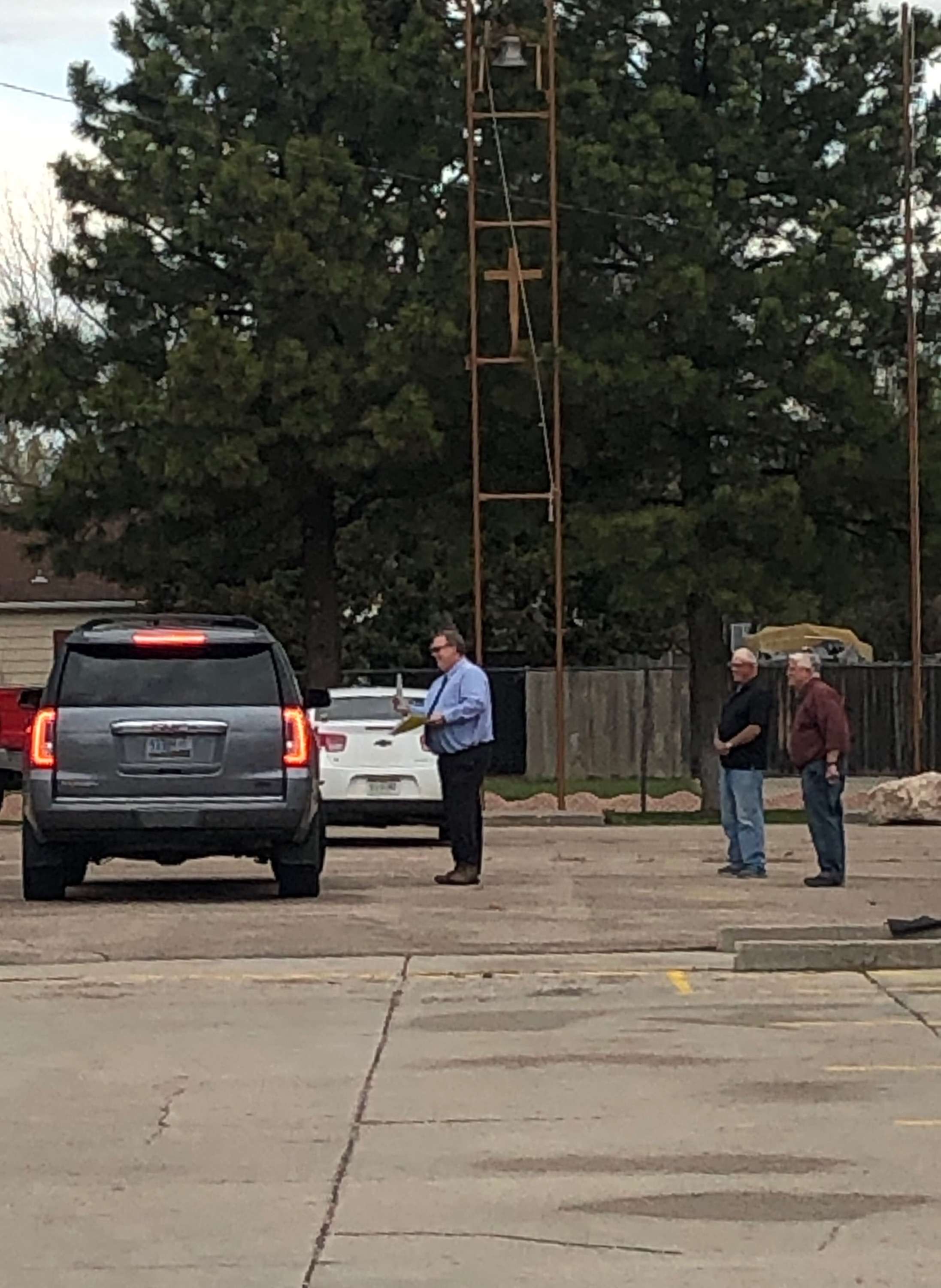 SAA school board president, Tom Burke, SAA Principal, Rodney Wilhelm, and Fr. Tim Stoner in front of the school on the blacktop presenting the graduates with their diplomas and awards.&nbsp;