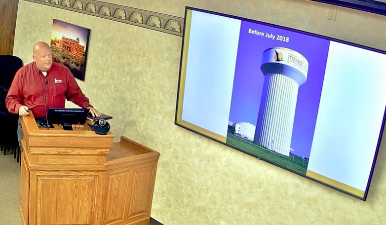 Jeff Crispin, city director of water resources, displays the former water tower logo.