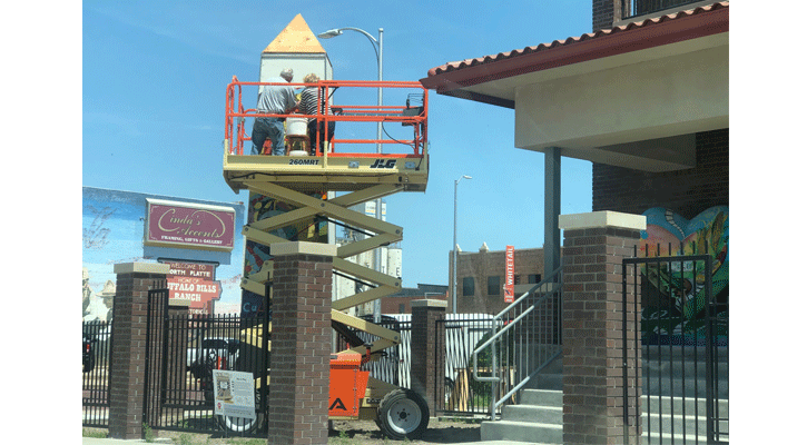 Local artists work on completing the new 15-foot art Obelisk at the Prairie Arts Center in Downtown North Platte.