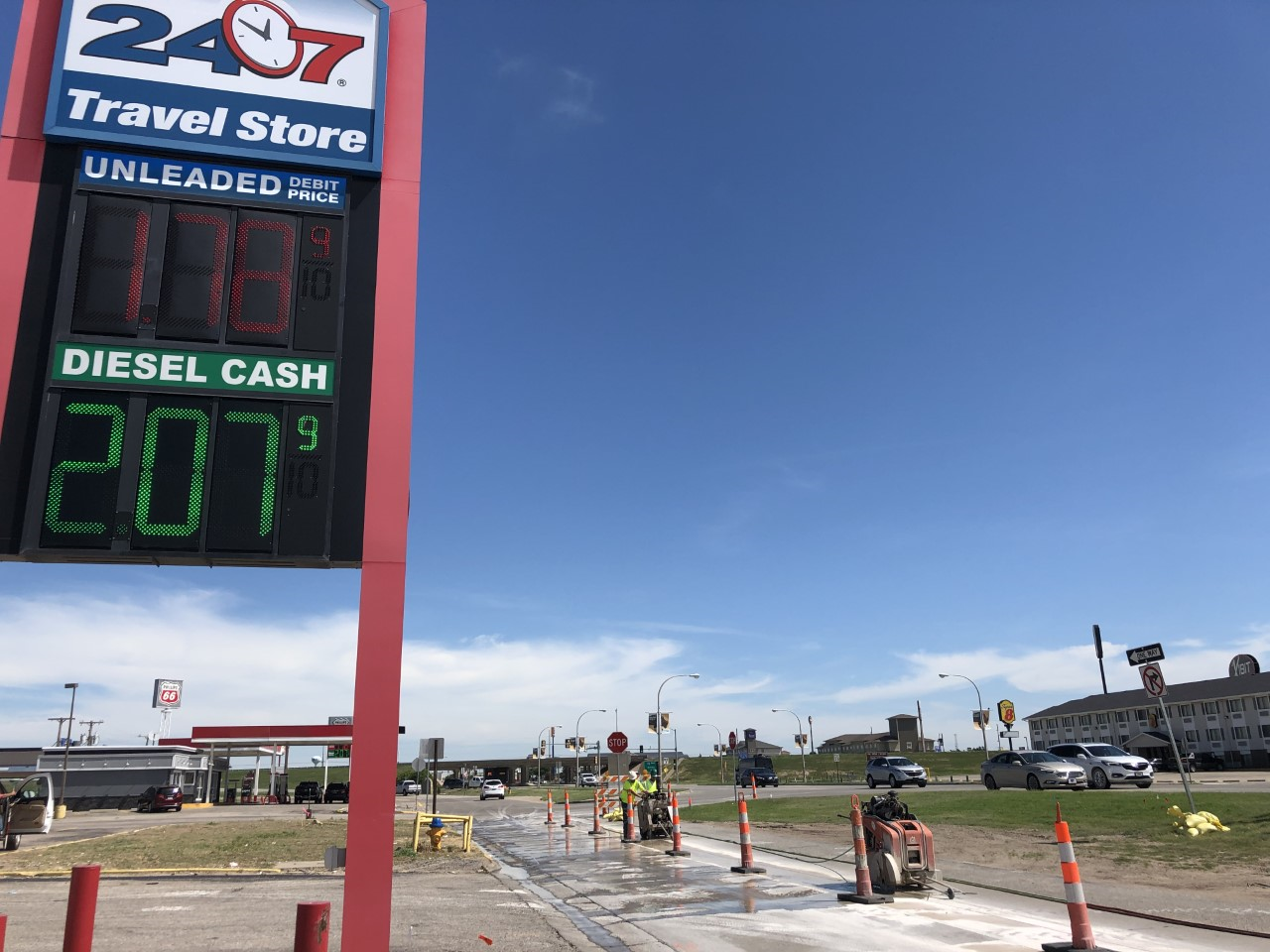 Workers with Smoky Hill Construction, Salina, the contractor for the N. Vine project, begin demolishing concrete Tuesday on the frontage road in front of 24/7 Travel Store.