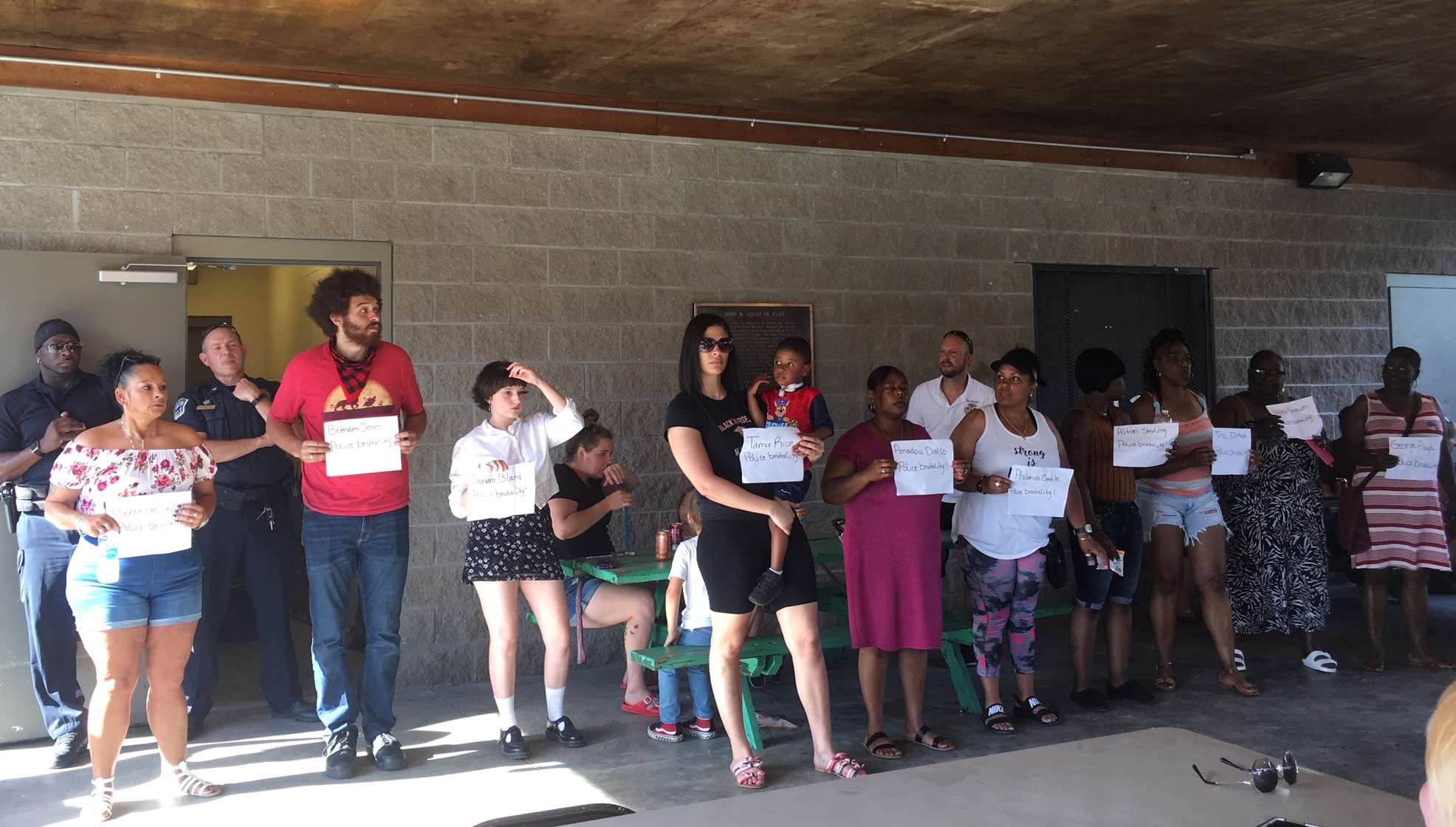 Several individuals at the community cookout event on Tuesday held signs with the names of Breonna Taylor, Botham Jean, Sandra Bland, Tamir Rice, Amadou Diallo, Philando Castile, Alton Sterling, Tina Ezekwe, Walter Brown and George Floyd . One of the speakers at the event said each name is someone killed by police brutality and asked everyone to keep the families of each in their prayers./Photo by Sarah Thomack