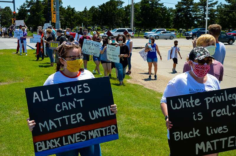 Protesters at the intersection of 27th and Vine in Hays Sunday.&nbsp;