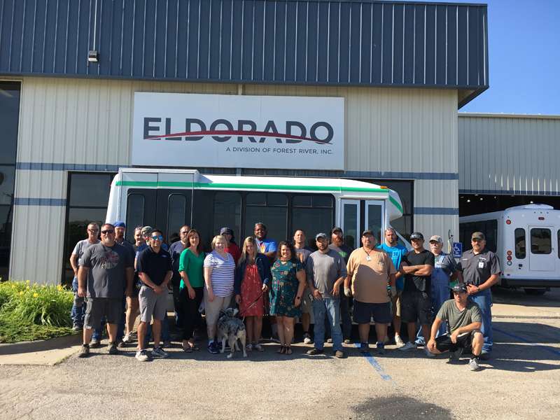 <b>Representatives of Big Brothers Big Sisters Salina and Long McArthur joined some of the ElDorado employees who helped refurbish the BBBS bus. The group gathered this morning to celebrate the completion of the project. </b>Photo courtesy ElDorado